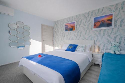 a bedroom with two beds and a teddy bear at Gold Coast Photography Inn Cascais in Estoril