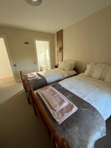 a bedroom with two beds and a table in it at Time Out Accommodation in Cahersiveen