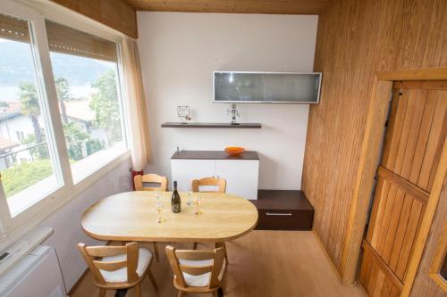 a small dining room with a wooden table and chairs at Villa Laura in Germignaga