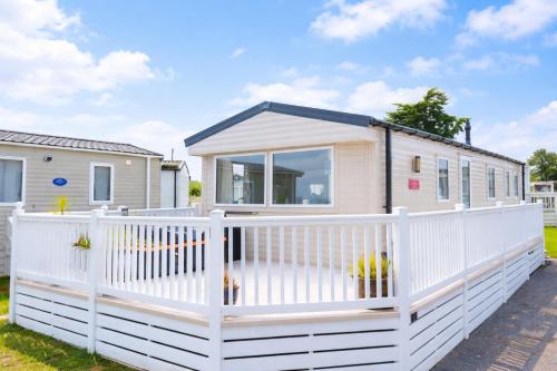 a tiny house with a white fence at Springfield B6 in Brixham