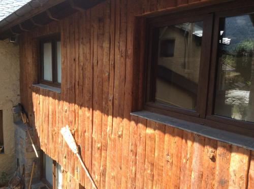 a house with two windows on the side of it at Casa Rural Era de Ferro in Erill la Vall