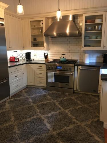 a kitchen with stainless steel appliances and white cabinets at Midtown Vibe in Sacramento