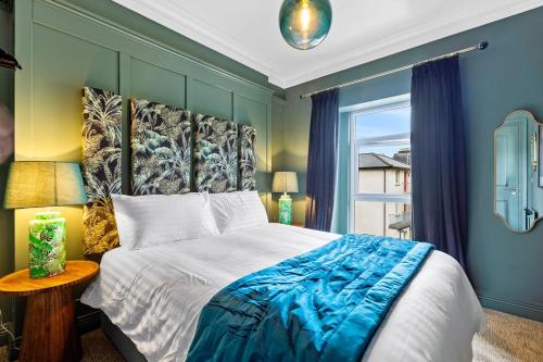 a bedroom with a large bed and a window at Hestia House in Derry Londonderry