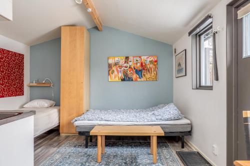 a small bedroom with a bed and a table at Cosy stay in southern Malmo in Malmö