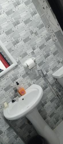 a bathroom with a toilet and a sink at Residence Maachaalah in Saint-Louis