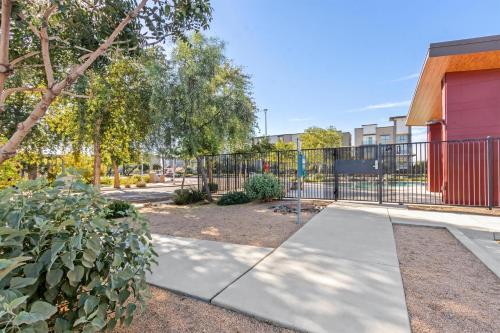 a park with a fence and a sidewalk at Sonesta Simply Suites Avondale in Avondale