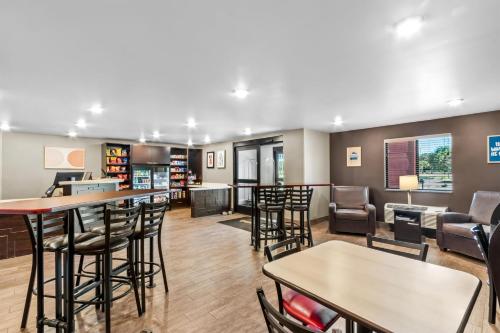 a bar in a library with chairs and tables at Sonesta Simply Suites Avondale in Avondale