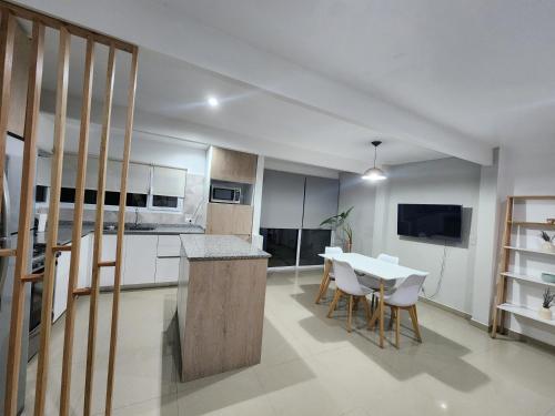 a kitchen and dining room with a table and chairs at Luz de Sol in Plottier