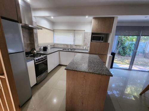 a large kitchen with white cabinets and a counter top at Luz de Sol in Plottier