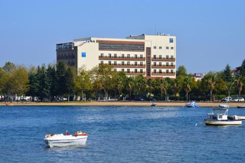 two boats in the water in front of a building at TRYP by Wyndham Izmit in Kocaeli