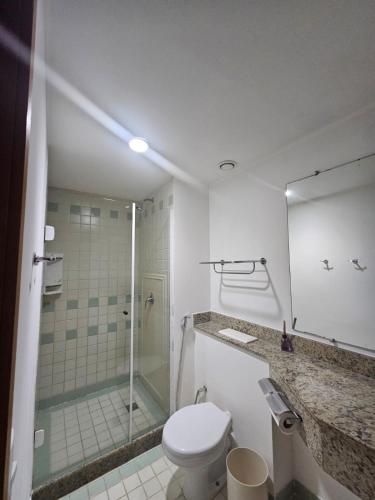 a bathroom with a toilet and a glass shower at Flat Borges Lagoa Vl Mariana Ibirapuera com garagem UH1007 in São Paulo
