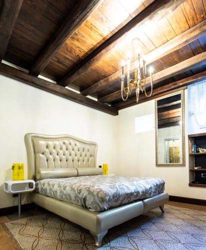 a bedroom with a bed and a chandelier at B&B Al Convento in Potenza