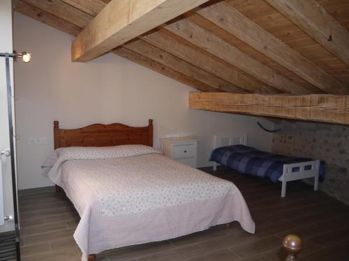 a bedroom with a large bed and wooden ceilings at Agroturismo Erlete Goikoa -ESTAMOS EN EL CAMINO DE SANTIAGO -WE ARE ON THE CAMINO DE SANTIAGO in Deba