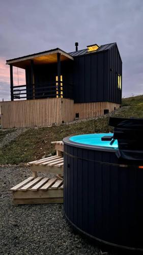 a building with a swimming pool in front of a house at Feeling Freedom in Tukhlya