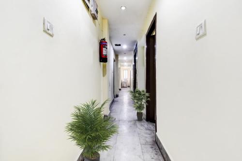 a corridor with plants in a white building at Hotel O Lord Shiva in Bankipur