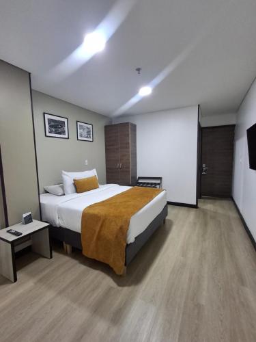 a hotel room with a bed and a chalkboard at Hotel WLH Gold Bogota in Bogotá
