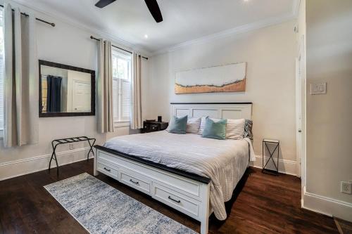 a bedroom with a bed in a room with white walls at Charming Historic Condo with Pool in Savannah