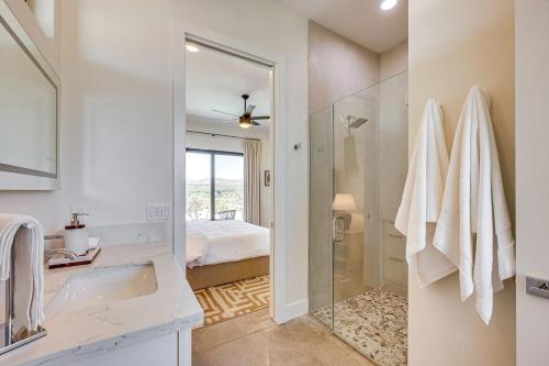a bathroom with a sink and a shower and a bed at Luxury Desert Villa with Pool and Spa in Yucca Valley