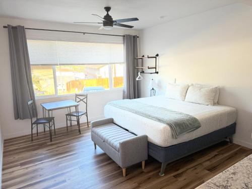 a bedroom with a bed and a table and a window at Unit 3 Waena Inn Newly Renovated Maui Private Suite in Wailuku