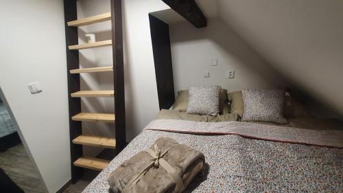 a bedroom with a bed with a pillow on it at U Studánky in Drnovec