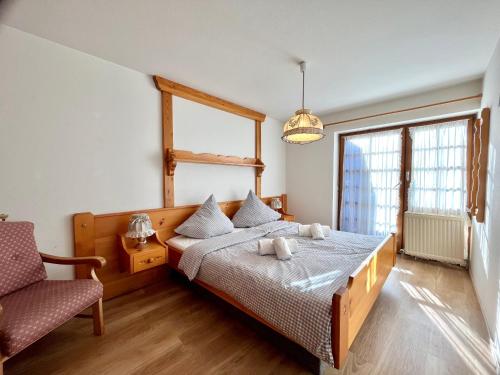 a bedroom with a bed and a chair at Sonnenstüble in Oberstdorf