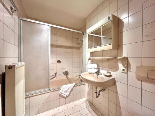 a small bathroom with a sink and a shower at Sonnenstüble in Oberstdorf