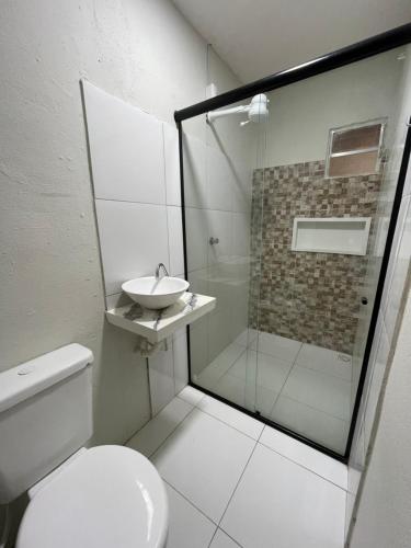 a bathroom with a toilet and a sink and a shower at Flat Praia do Pontal in Baía Formosa