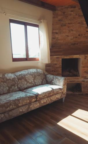 a living room with a couch and a fireplace at Koltincalli in Xico