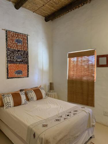 a bedroom with a large bed and a window at AGAVE HOUSE in Prince Albert