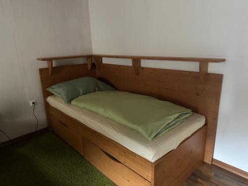 a wooden bed with two pillows on it at Apartment Obervellach in Obervellach