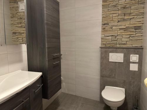 a bathroom with a toilet and a sink at Apartment Obervellach in Obervellach