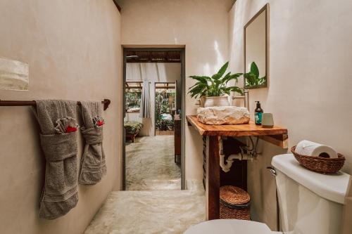 a bathroom with a toilet and a sink at Casa Arkaana Eco Retreat in Tulum