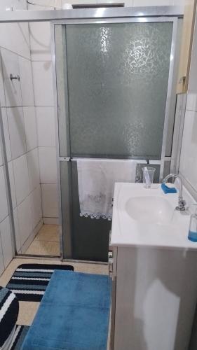 a bathroom with a shower with a sink at Pousada da bancários in São Gabriel