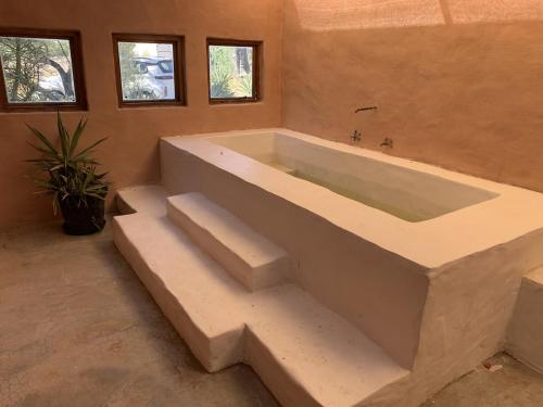 a large bath tub in a room with stairs at AGAVE HOUSE in Prince Albert