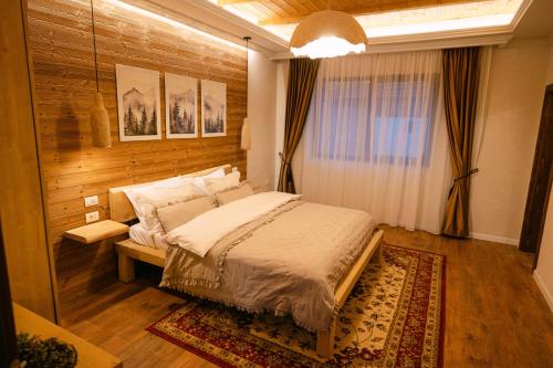 a bedroom with a large bed in a room at Chalet Village Bran in Bran