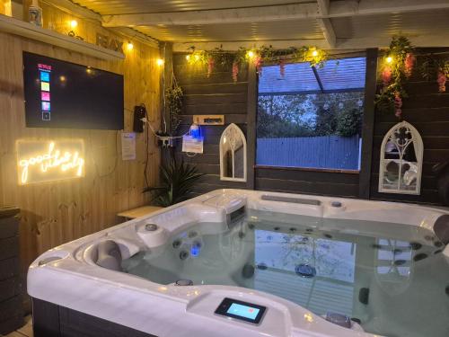 a jacuzzi tub in a room with a tv at Kozy Kabin in Ballyduff