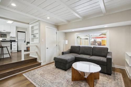 a living room with a couch and a table at Pet-Friendly Private Cottage In Tahoe Park in Sacramento
