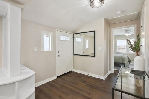 a living room with a door and a mirror at Pet-Friendly Private Cottage In Tahoe Park in Sacramento