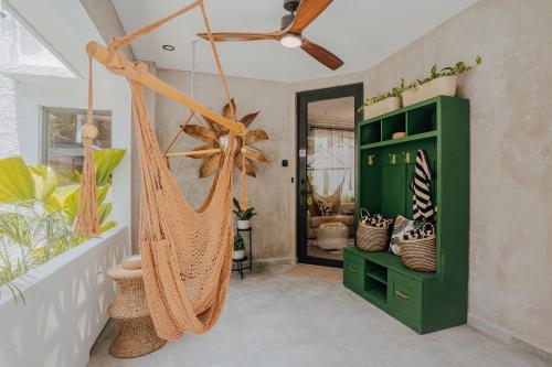 a hammock in a room with a bathroom at Flor De India in San Juan