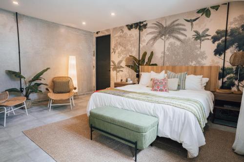 a bedroom with a large bed and a chair at Flor De India in San Juan