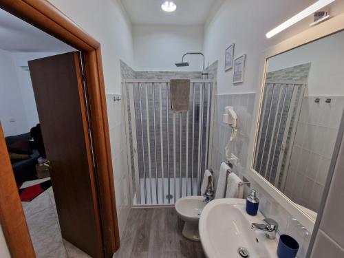 a bathroom with a sink and a toilet at Vicolo Stretto Guest House Centro storico in Vibo Valentia