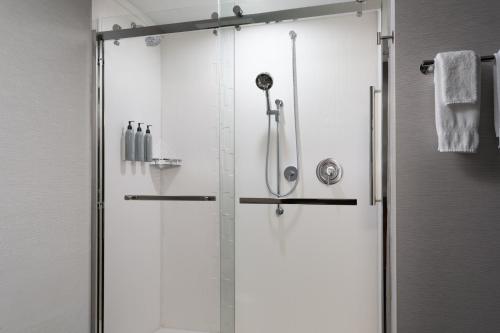 a shower with a glass door in a bathroom at Courtyard by Marriott Lake City in Lake City