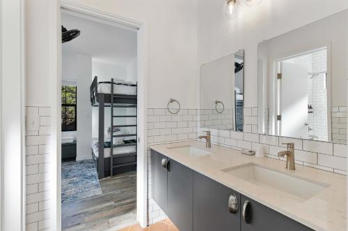 a bathroom with two sinks and a mirror at 7A Ranch in Wimberley
