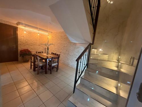 a dining room with a table and chairs and a staircase at Posada Castillo in Zacatlán
