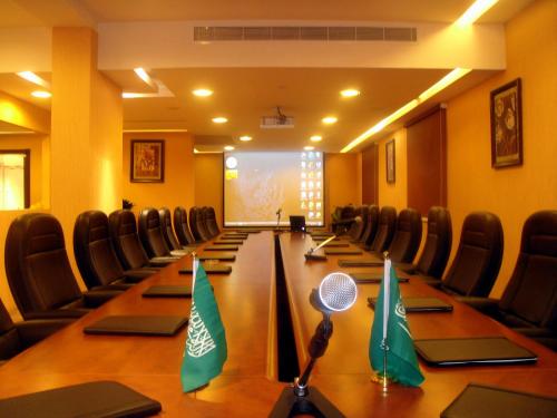 a conference room with a long table and chairs at Jazan Inn Hotel in Jazan