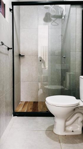 a bathroom with a toilet and a glass shower at Apartamento completo com lazer in João Pessoa