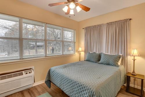a bedroom with a bed and a fan and windows at Private Boat Launch! Riverfront Jefferson Retreat in Jefferson