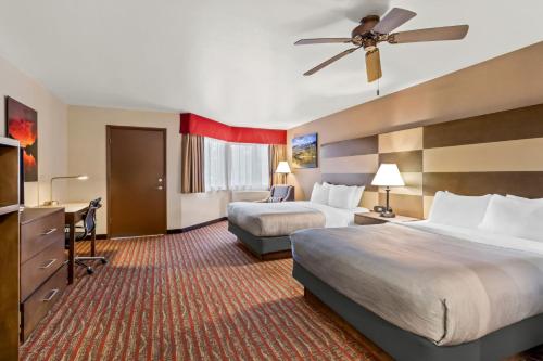 a hotel room with two beds and a flat screen tv at Quality Inn near Rocky Mountain National Park in Estes Park