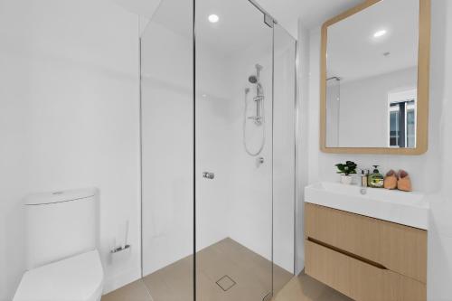 a bathroom with a glass shower and a sink at Brisbane One Views Level 15 2BR Apartment in Brisbane