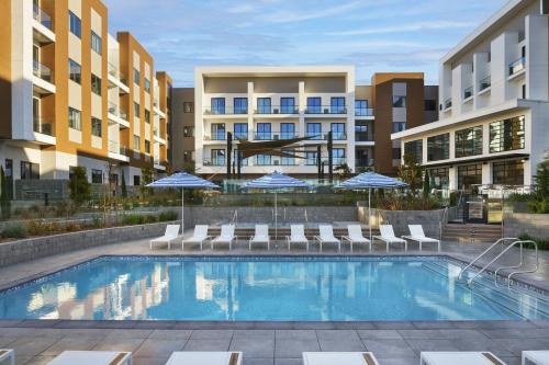 an image of a swimming pool at a apartment complex at Courtyard by Marriott Sand City Monterey in Sand City